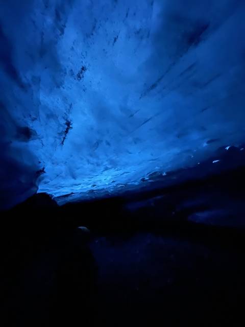       A dark ice cave interior.
  