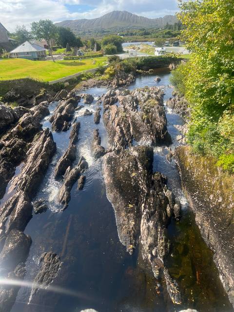 River with rocky outcrops and surrounding landscape.