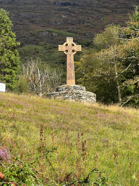 Celtic cross monument located in a grassy area.