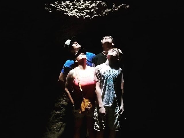 People looking up in a dark environment.