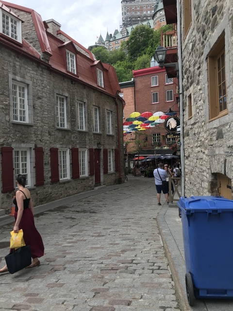       Street alley with colorful umbrellas hanging overhead.
  
