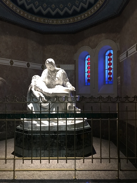       Statue of a historic religious figure in a chapel.
  