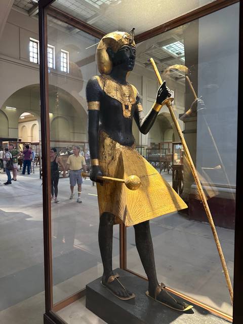       Intricate statue of an Egyptian deity in a museum.
  