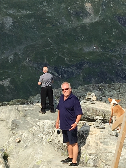 People enjoying a scenic viewpoint on rocky terrain.