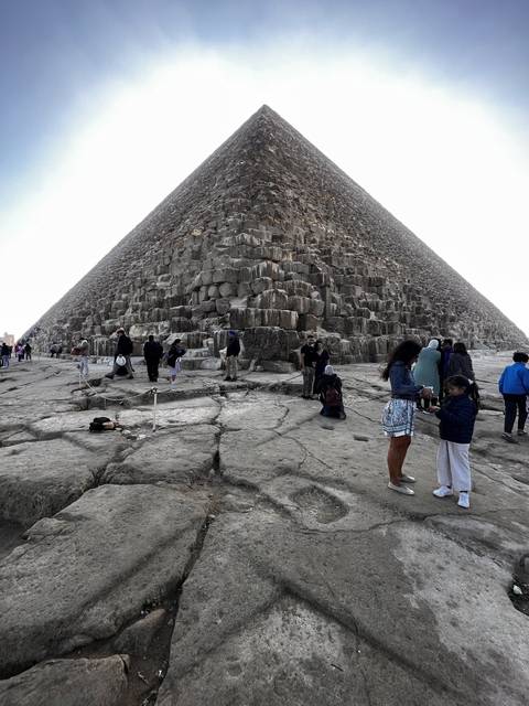       People visiting a pyramid.
  