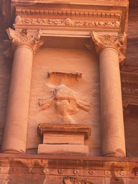       Close-up of an ancient carved stone relief.
  