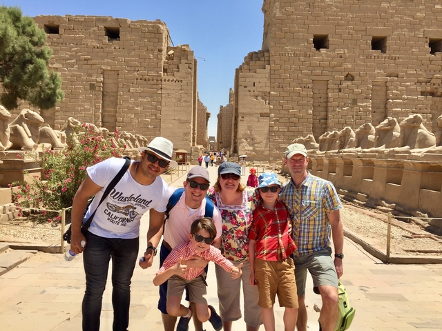       Group of people at an ancient Egyptian temple complex.
  