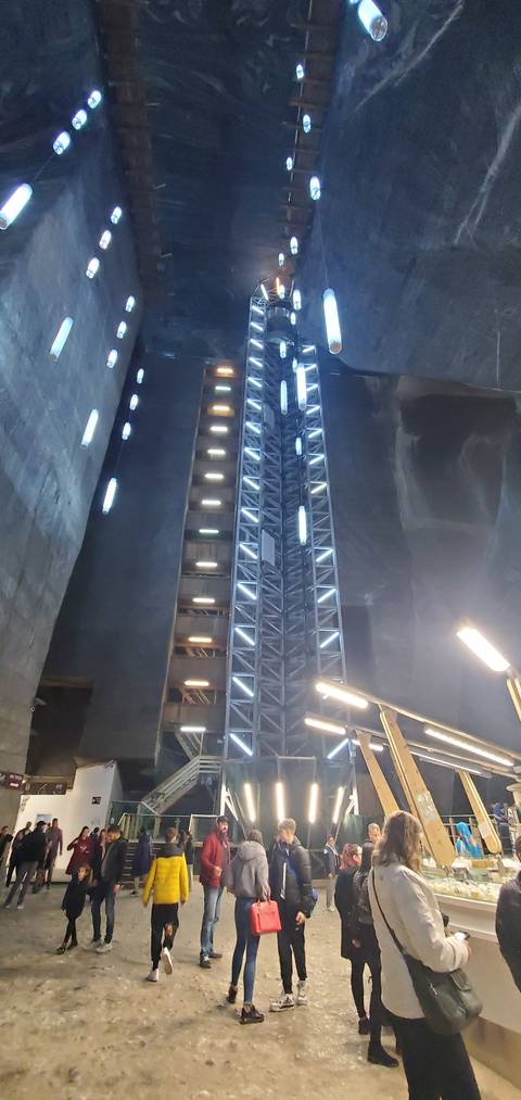 Large underground hall with people and architectural lighting.