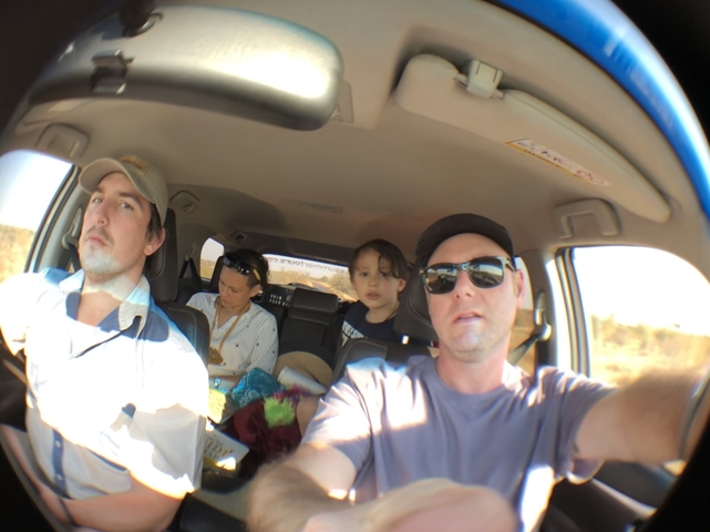 Group of people inside a vehicle taken with a fisheye lens.