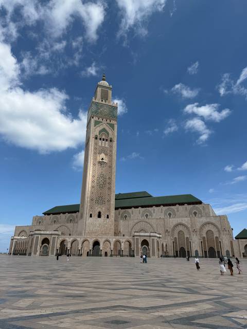Large mosque with people near the entrance.