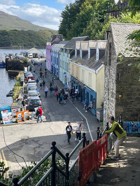 Busy street in a small town with colorful buildings.