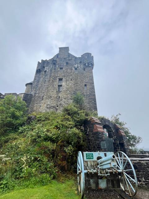 Old stone fortress with a cannon outside.