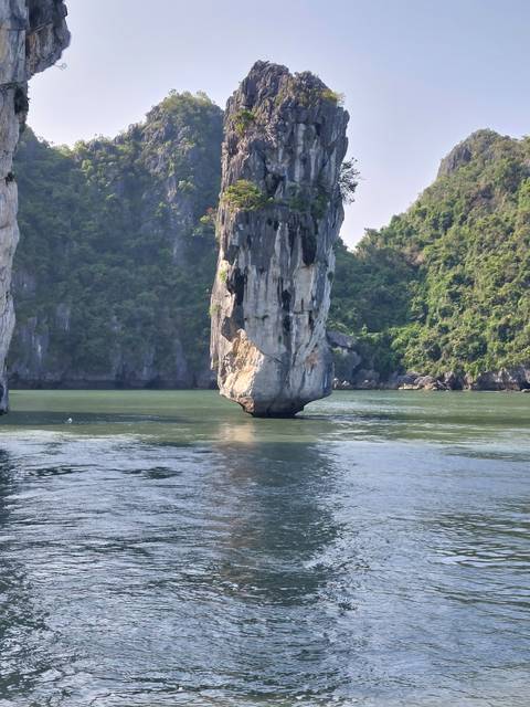 Limestone rock formation rising out of a body of water.