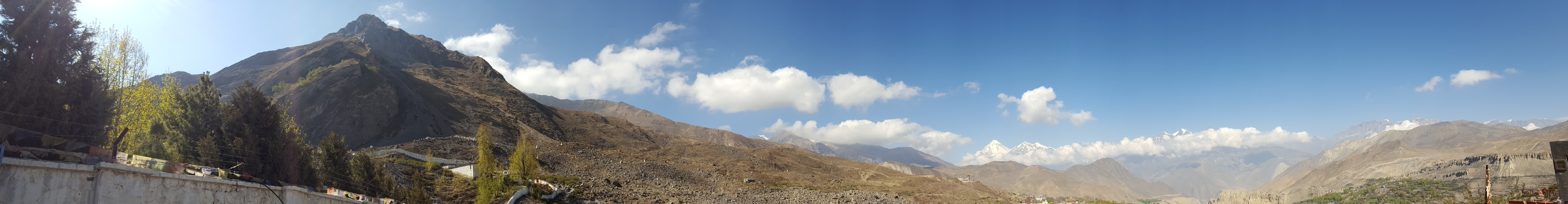       Mountain landscape with scattered clouds.
  