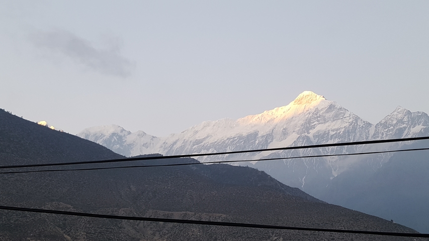       Snow-capped mountain range with a clear blue sky.
  