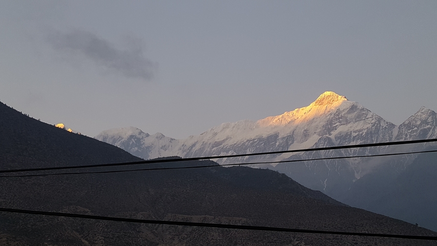       Snow-capped mountain range with a clear blue sky.
  