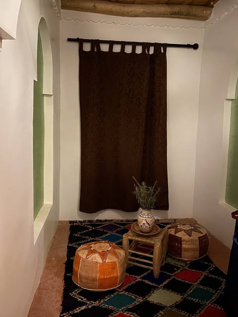       Cozy corner with a curtain and traditional decor.
  