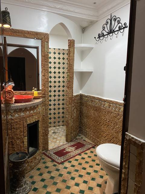       Unique bathroom with mosaic tiles.
  