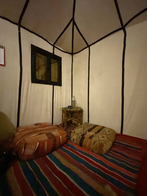       Interior seating area in a traditionally decorated tent.
  