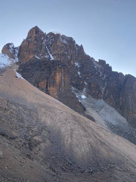 Rocky mountain landscape with snow patches.