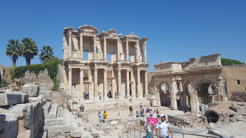 Ancient stone ruins with people exploring.