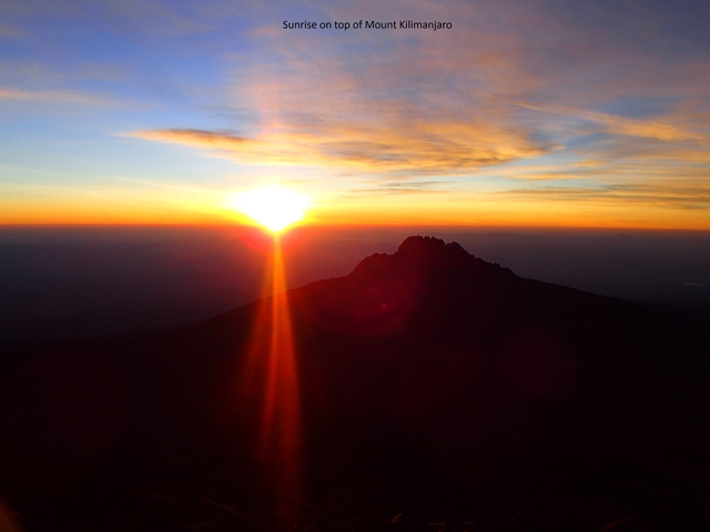       Silhouette of a mountain peak during sunrise.
  