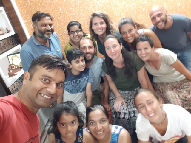       Group of people posing indoors with bright smiles.
  