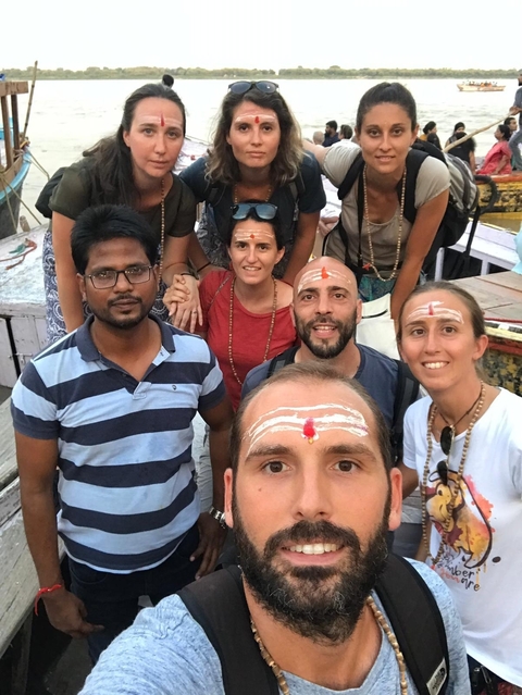       Group of people with traditional markings on their foreheads posing together.
  