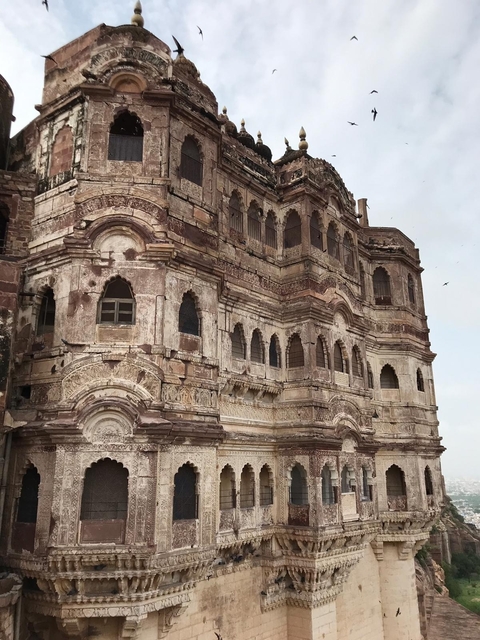 Intricate stone facade of a historic building with detailed carvings.
