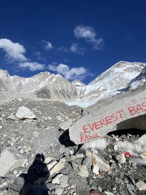 Rock with 'Everest' written on it against a mountain backdrop