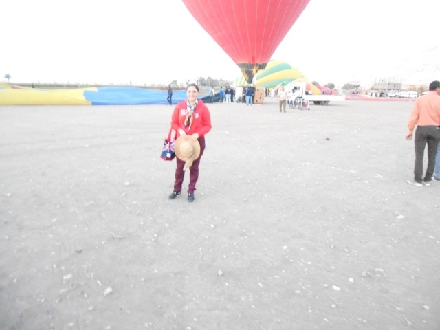 Blurry image of a person standing near a hot air balloon.