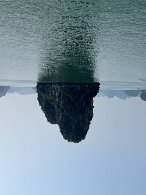 A solitary rock formation in the water.