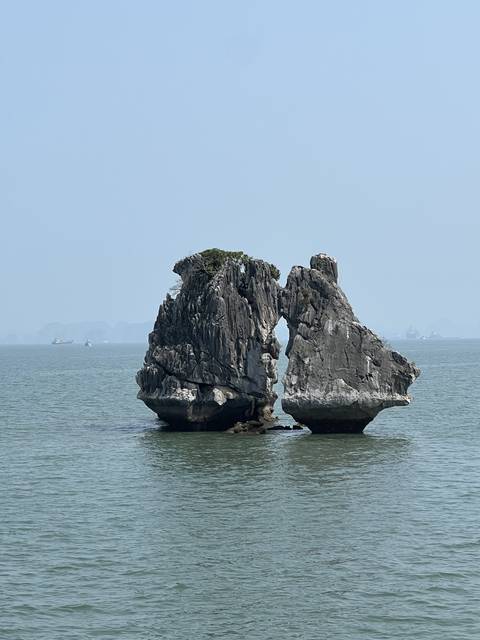 Twin rock formations jutting out of the water.