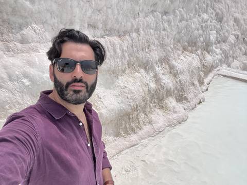 Upside-down image of a man in sunglasses with a textured background.