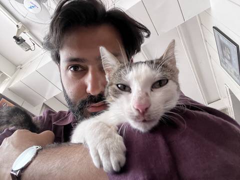 Upside-down image of a man and a cat indoors.