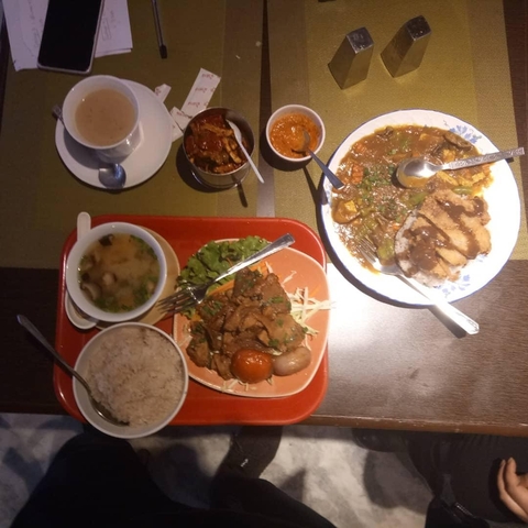       Array of Bhutanese dishes served in bowls and plates
  