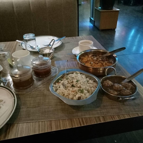       Table with local dishes and beverages in a restaurant.
  