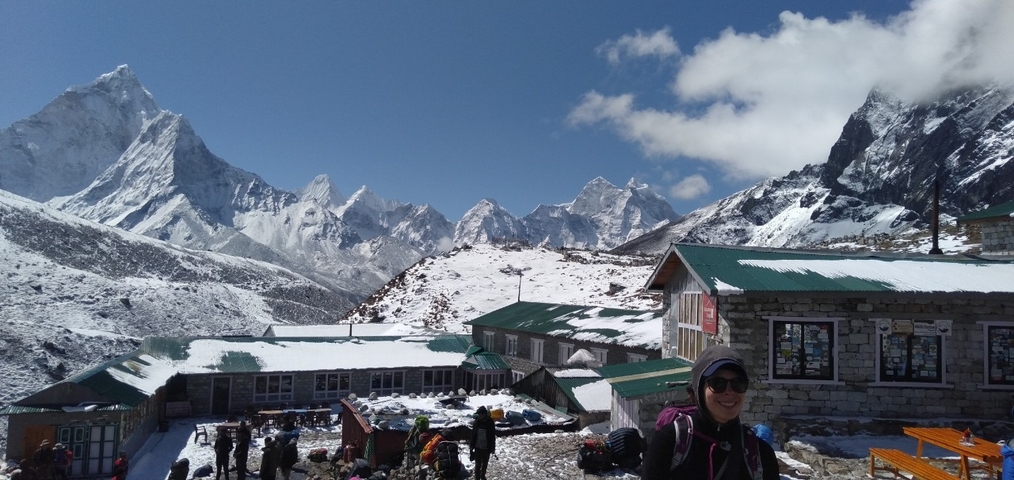 Mountain landscape with snow and a building.
