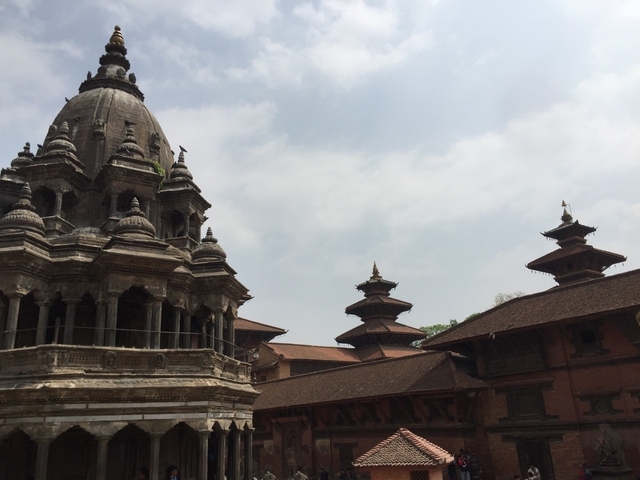       Buildings with ornate architecture against a cloudy sky.
  