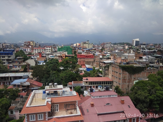       Aerial view of a city with densely packed buildings.
  