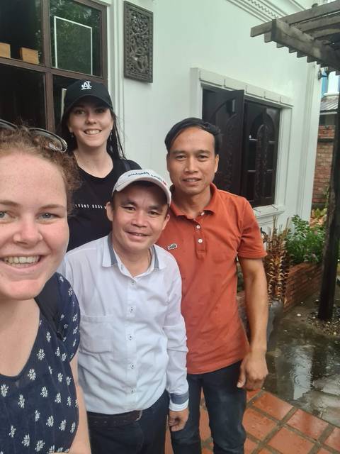       Group photo outside a building.
  