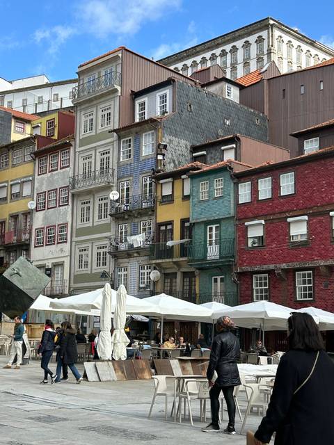 A colorful facade of buildings with outdoor seating.