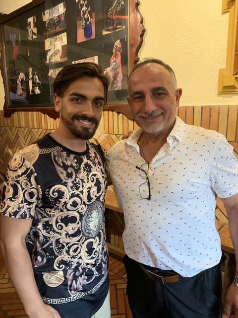 Two men posing in an indoor setting.
