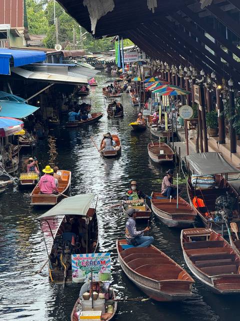 A busy floating market with multiple boats.