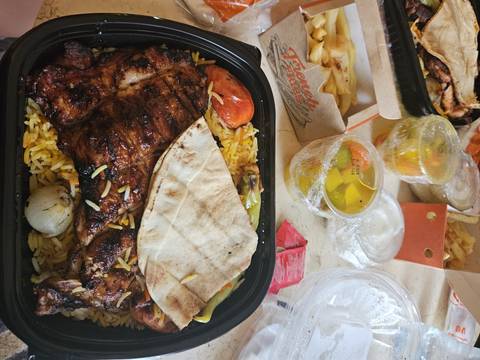 A meal with grilled meat, rice, and vegetables.