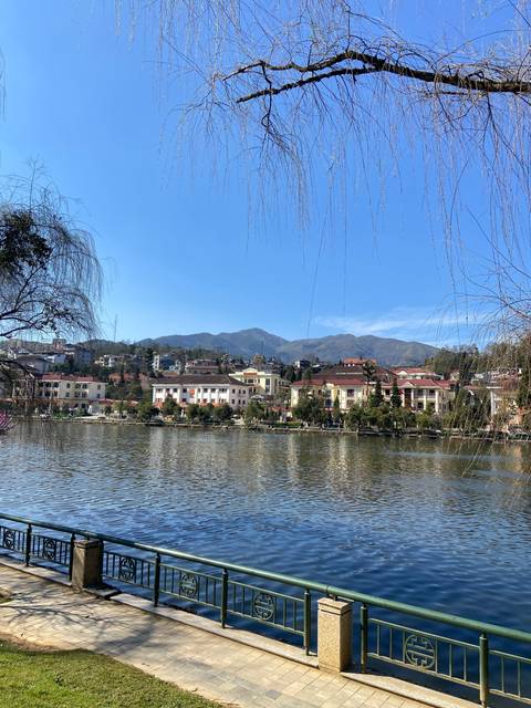 Urban landscape with waterway and distant mountains.