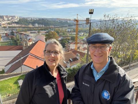 Couple with a cityscape view in the background.