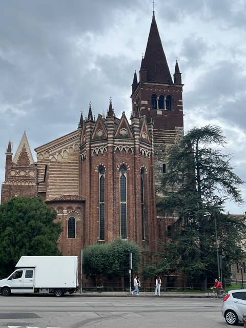       Large brick church with gothic architecture.
  