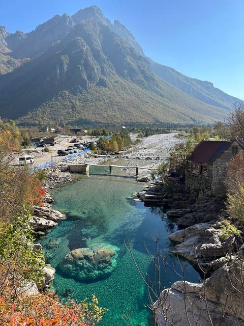       Clear turquoise stream running through rocky terrain.
  