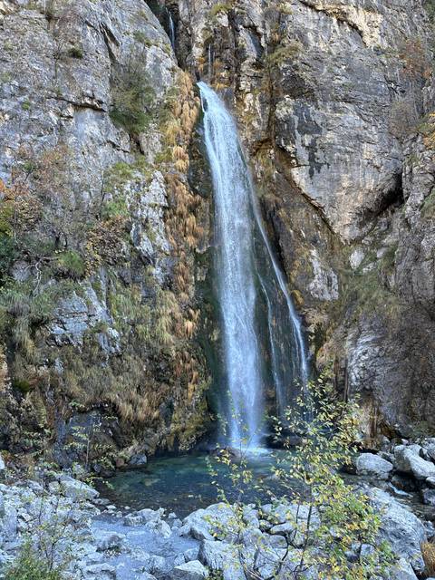       Waterfall cascading down rock formation.
  